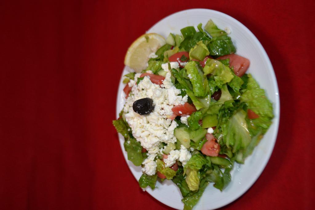 Mediterranean Salad · Fresh tomatoes, iceberg lettuce, green peppers, Kirby topped with feta cheese, olive oil and lemon juice.