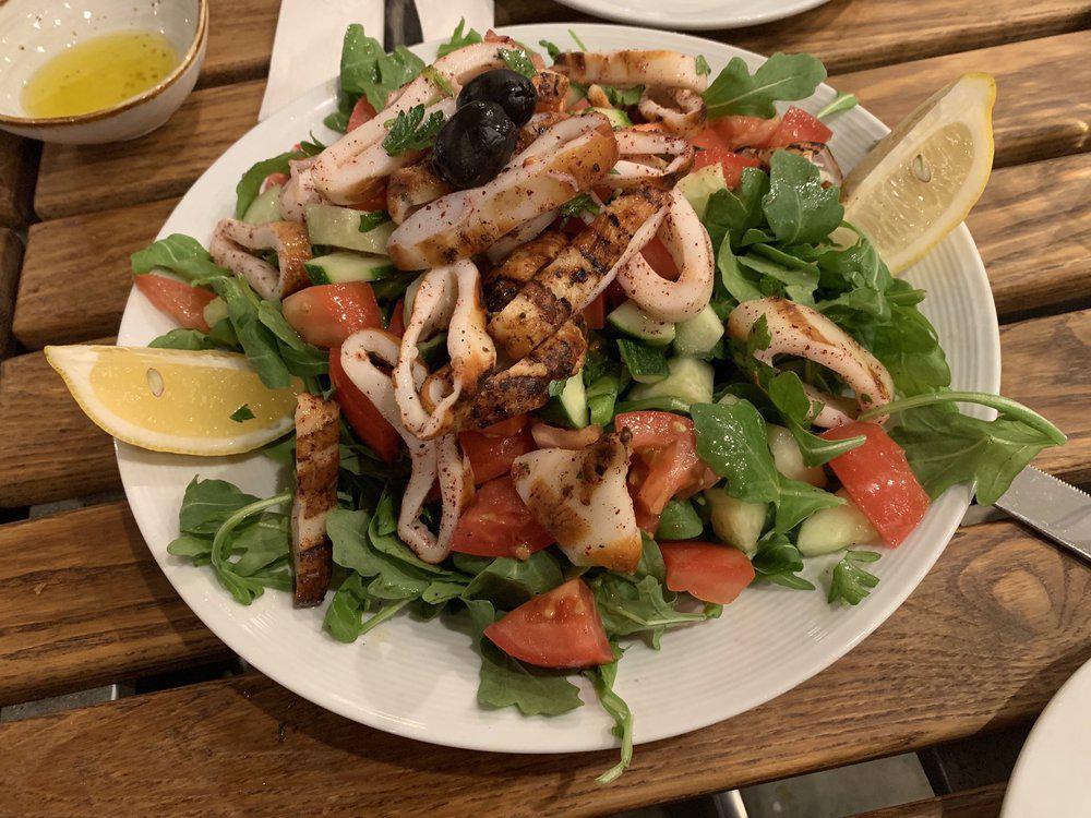 Calamari Salad · Arugula, Kirby, tomato, onion, lemon juice and olive oil topped with grilled calamari.