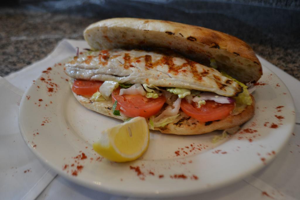 Bronzini Sandwich · Homemade bread. Comes with red cabbage, iceberg lettuce, tomato, onion, parsley, olive oil and lemon juice.