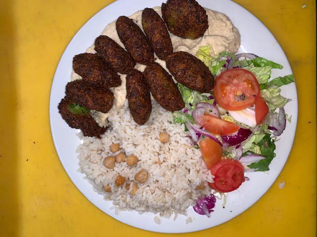 9 Piece Dinner Falafel Plate · Lightly fried vegetable balls made of chickpeas, celery, garlic, parsley, cilantro, tahini served with hummus, rice and salad.