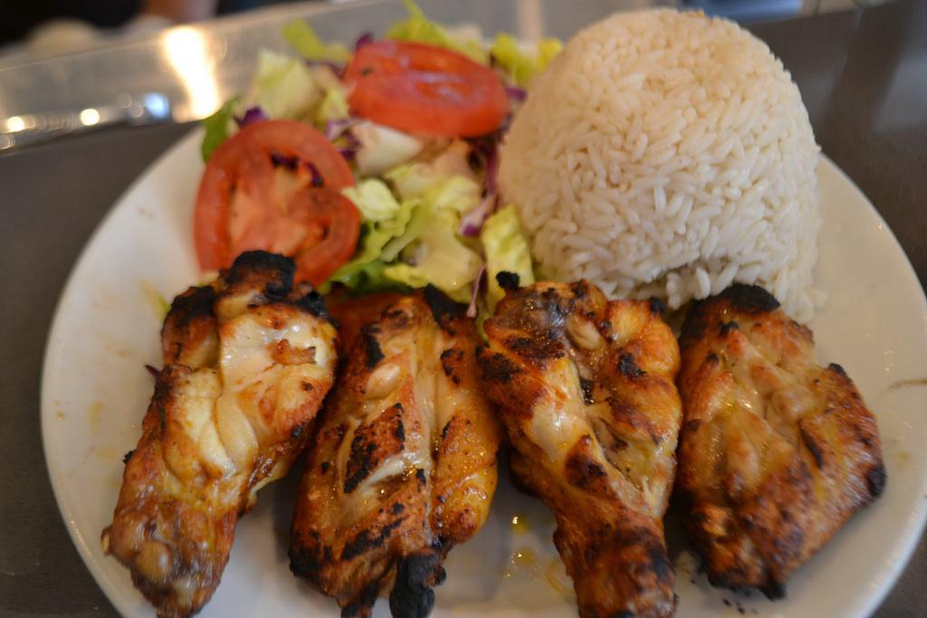 Chicken Wings · Marinated chicken wings grilled to taste. Served with salad and side.