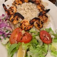 Shrimp Kebab · Char-grilled jumbo shrimps served with salad and rice.