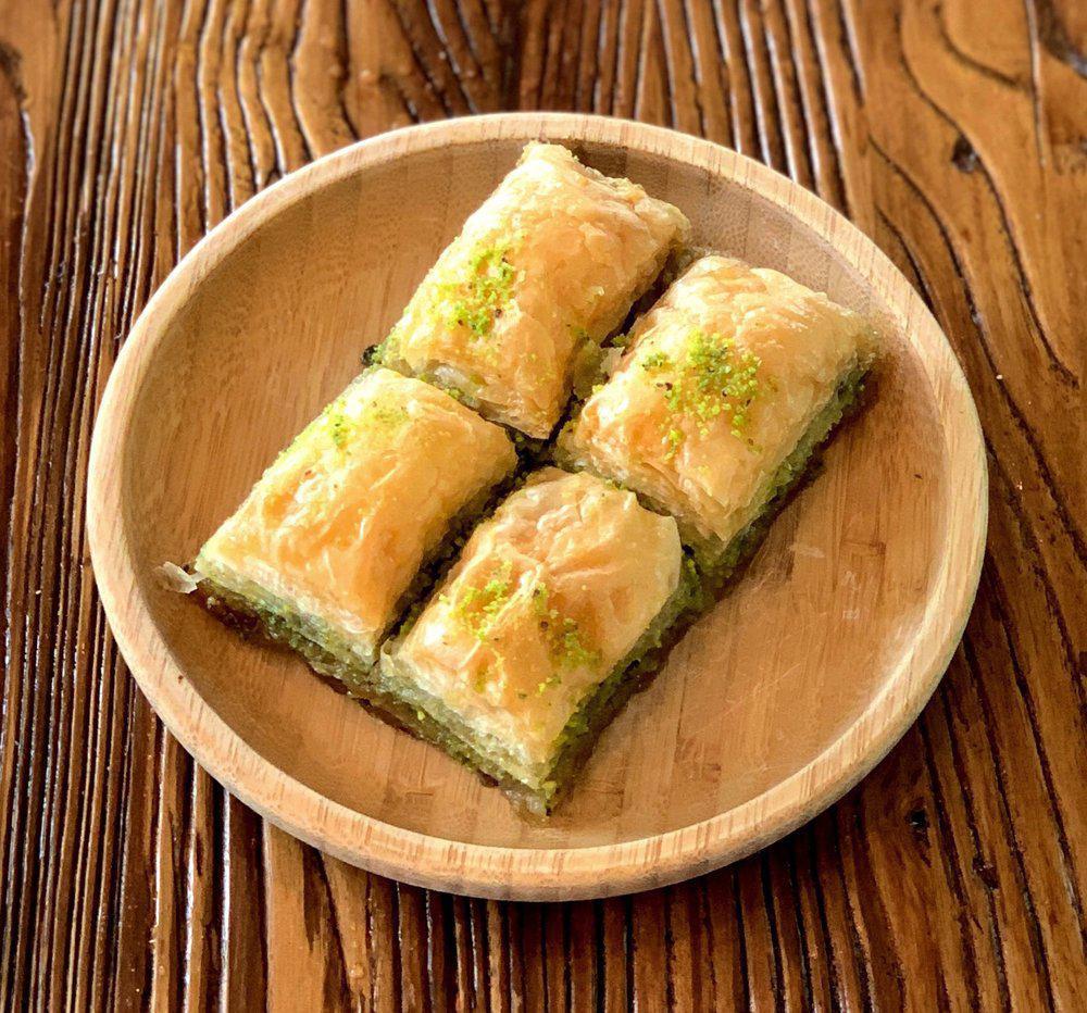 Baklava and Kinds · Sweet pastry made of extremely thin sheets of fillo dough layered with chopped nuts and honey syrup baked with butter and cut into diamond shapes.