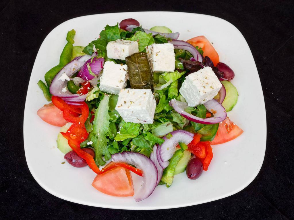 Greek Salad · Lettuce, tomatoes, cucumbers, olives, feta, onions and grape leaves.