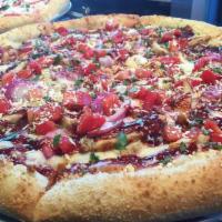 BBQ Chicken Pizza · Texas-style marinated chicken, sweet red onions, tomatoes and feta cheese crumbles on a bed ...