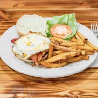 La Tejana Burger · 8 oz seasoned beef patty topped with two fried eggs, crispy bacon, yellow american cheese le...