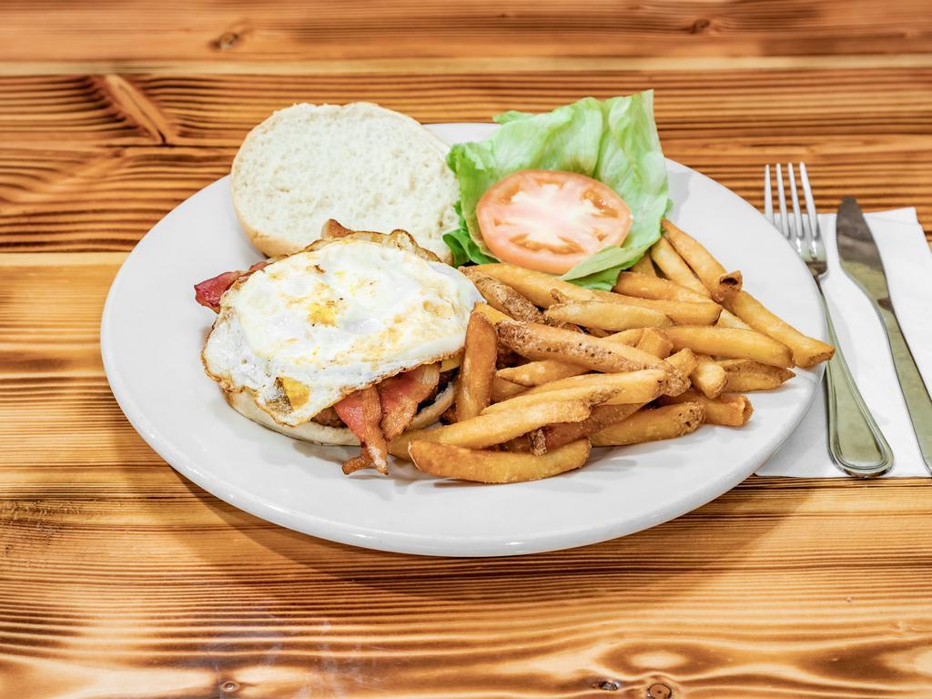 La Tejana Burger · 8 oz seasoned beef patty topped with two fried eggs, crispy bacon, yellow american cheese lettuce & tomato.  