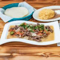 Steak a la Mexicana · Sauteed steak with tomato, onion and jalapeno. Accompanied with rice, beans and soft corn to...