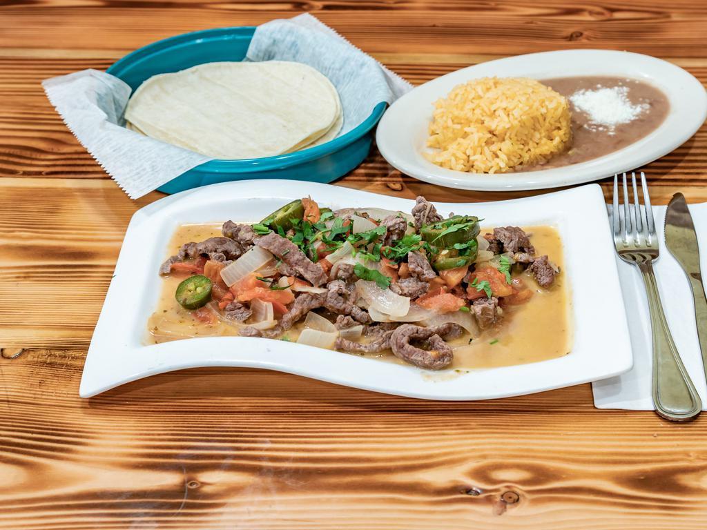 Steak a la Mexicana · Sauteed steak with tomato, onion and jalapeno. Accompanied with rice, beans and soft corn tortillas.