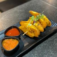 Tostones · Served with salsa and wood vinegar ketchup