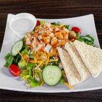 Buffalo Chicken Salad · Crispy breaded chicken, Jack and cheddar cheese, cucumber, tomato, shredded carrots, bell pe...