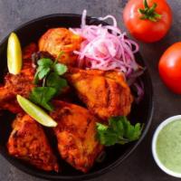 Tandoori Chicken. · Chicken on the bone marinated in yogurt with aromatic spices and grilled.