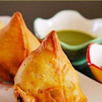 Samosa. · Fried pastry with a savory filling of spiced potatoes, onion, peas & lentils.