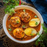 Egg Masala. · Traditional Indian curry with boiled eggs simmered in an onion-tomato gravy along with hot s...
