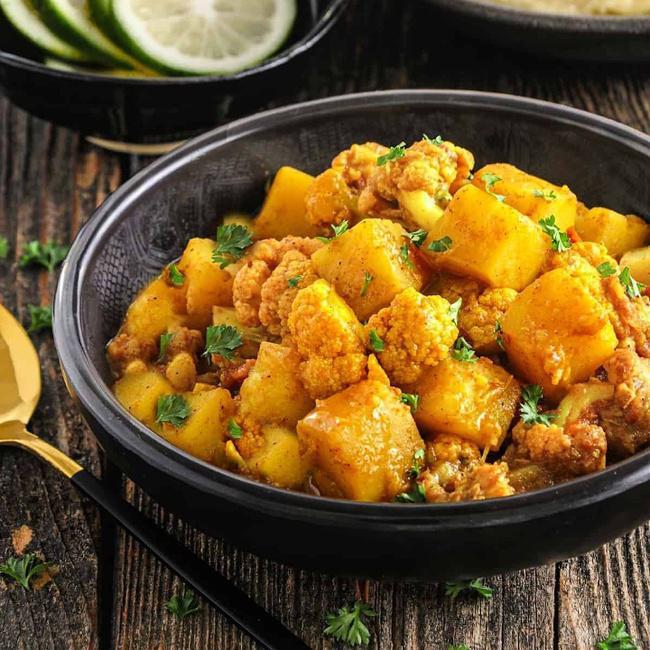 Jeera Aloo Gobi. · A delicious North Indian dish made with potatoes, cauliflower, cumin spices, and herbs.