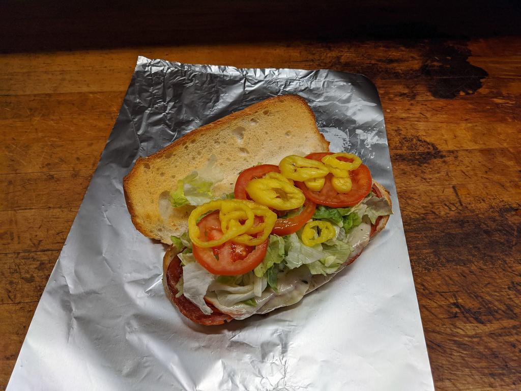 Italian Sub · Salami, Pepperoni, Capicola Ham, Provolone Cheese, Topped with Lettuce, Tomato, Banana Peppers, and Red Wine Vinaigrette Dressing