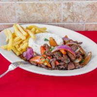 Lomo Saltado · Stir fry sirloin sauteed with onions and tomatoes. 
Served with rice and french fries