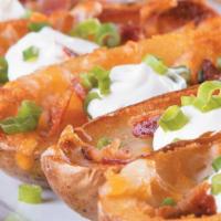 Potato Skins · Topped with cheddar-jack cheese, bacon, green onions and seasoned sour cream 
