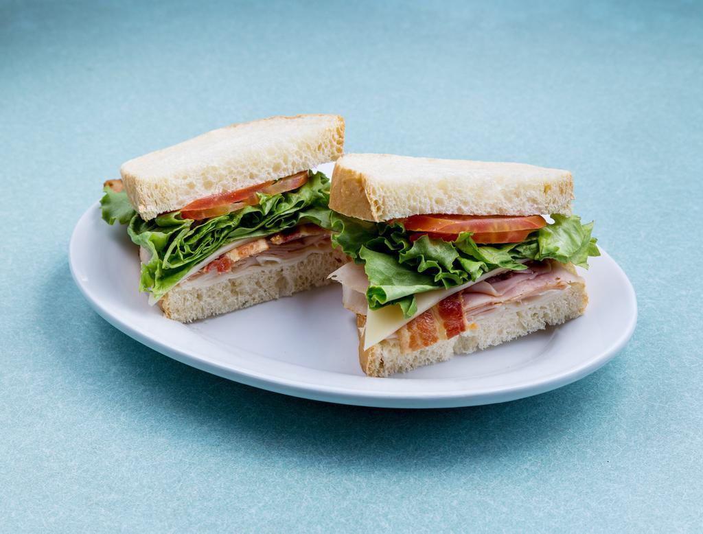 Classic Club Sandwich · Black Forest ham, oven gold turkey, bacon, lettuce, tomato and mayonnaise served on sourdough sandwich bread.