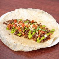 Carne Asada Burrito  ·  With: carne asada steak, whole beans, pico de gallo, avocado sauce.