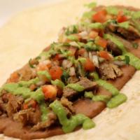 Carnitas Burrito  · With: carnitas, pico de gallo, avocado sauce, and chorizo refried beans.