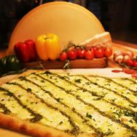 White Pesto Pizza · Mozzarella, ricotta, Parmigiano Reggiano and pesto sauce (no marinara sauce).