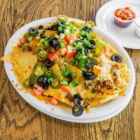 Nachos · Ground beef or chicken, fresh cooked corn tortilla chips, cheddar-jack cheese, olives, tomat...