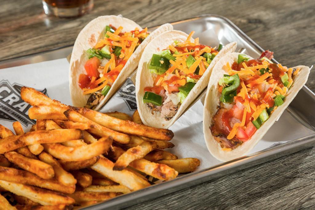 BBQ Taco Trio · One pulled pork, 1 pulled chicken and 1 smoked brisket taco each topped with cheddar cheese, diced onion, diced tomato, jalapeño, & BBQ sauce.