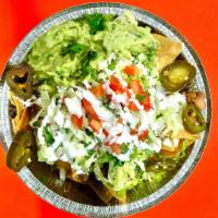 Nachos · Homemade chips with beans, quesillo, guacamole, jalapenos, sour cream, cotija cheese, lettuc...