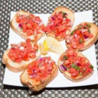 Bruschetta · Topped with tomato, onion and basil