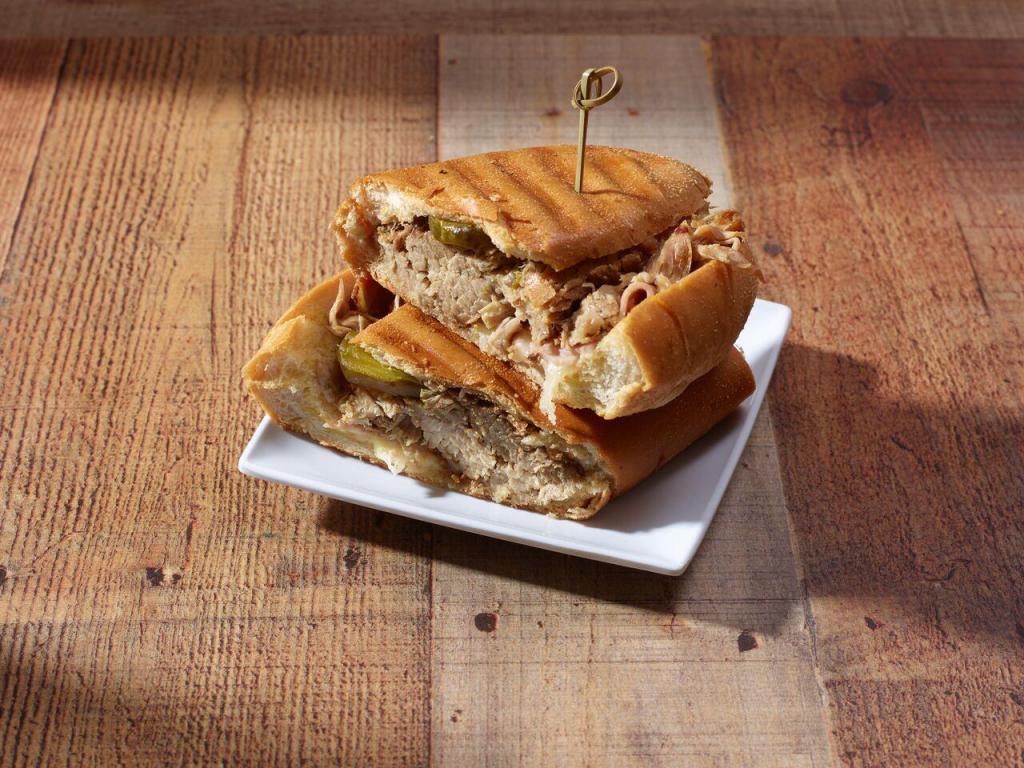 Cuban Sandwich · roast pork, swiss cheese, honey ham, pickles & garlic butter served on a toast cuban bread