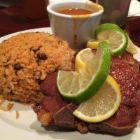 Chuletas Friats - Fried Pork Chops · Fried pork chops  served with yellow rice
