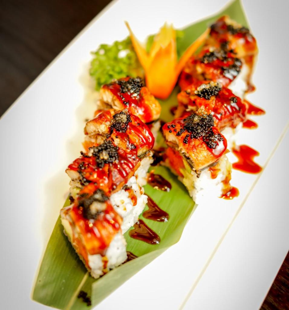 Flying Dragon Roll · Spicy tuna, avocado, crunch inside, topped with eel and black tobiko.