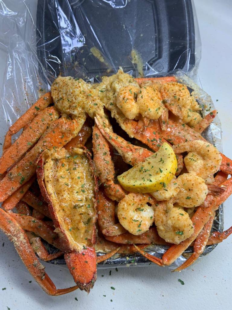 Lobster Tail, Double Snow Crab, and Shrimp · 6oz Maine Lobster Tail, 2 Fresh Alaskan Snow Crab Clusters, 8 Black Tiger Shrimp, 2 Ears of Corn, 3 Red Skin Potatoes, 4 oz of sauce and bib set.
