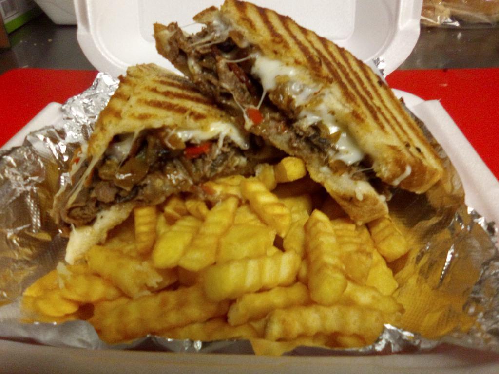 Really  Philly Melt  ·  Seasoned steak, sauteed peppers, mushrooms, caramelized onions with bacon and mozzarella cheese, grilled golden brown, served with house made chips or French fries 
