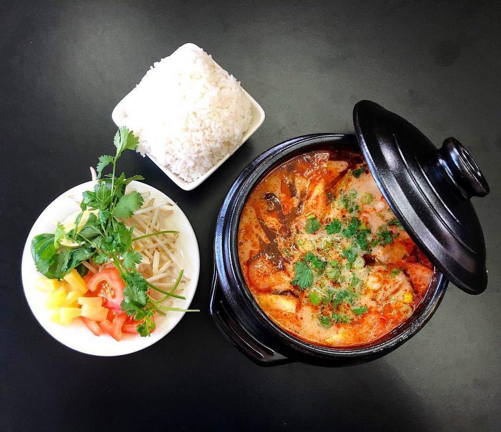 Vietnamese Tom Yum · This sweet and sour soup uses a chicken base broth, coconut milk, galangal, lemongrass, lime leaves, topped with straw mushrooms, pineapple, tomatoes, green onions, and cilantro. Served with rice, rice noodles, or glass noodles. Gluten-free.