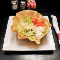Taco Salad Deluxe · A crisp flour tortilla filled with chicken or beef, beans, lettuce, tomatoes, shredded chees...