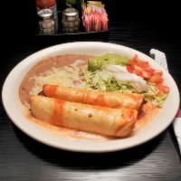 Soft Chimichangas · 2 flour tortillas filled with beef tips or chicken and beans. Topped with lettuce, tomatoes,...