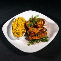 Herb-Tossed Wings · Bone-in wings in a fresh sage, thyme and scallion mix. Served with a side of yellow rice. At...