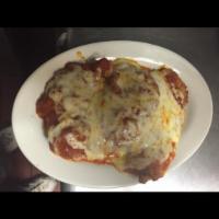 Chicken Parmigiana · Served with salad and choice of spaghetti or penne.