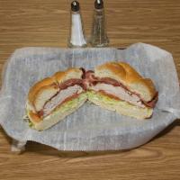 Turkey Club Sandwich · Thinly sliced turkey topped off with lettuce, tomato, crisp bacon, and cheese on your choice...