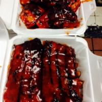 Family Pack Special · Includes 1 rack of ribs, 1 whole chicken, large fries, choice of 4 small sides and 4 cornbre...