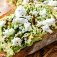 New Avocado Toast · Avocado spread, Lemon, Olive Oil, crumbled Feta and Red Pepper Flakes on a thin slice of  fr...
