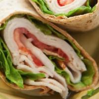 Turkey and Pepper Jack Cheese Wrap · Sliced turkey, pepper jack cheese, and baby spinach on a wrap.