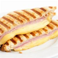 Ham and Swiss Cheese Panini · Sliced ham and swiss cheese on a grilled panini