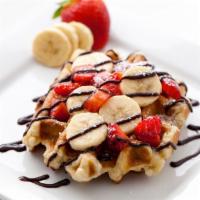 Strawberrynana Waffle · Leige waffle, strawberries, banana, whipped cream, chocolate drizzle and caramel drizzle.