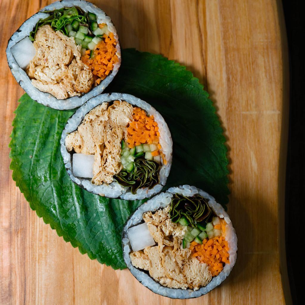 Yubu Kimbap (vegan) · Gluten-free kimbap roll with soy-marinated non-GMO yubu (tofu skins). Includes carrots, cucumbers, pickled radish, red leaf lettuce, sesame seeds, and sesame oil seasoned rice, all rolled together in a seaweed sheet.