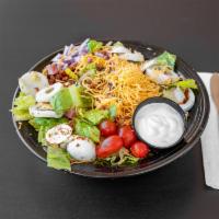 Chef Salad · Romaine lettuce, tomatoes, red onion, ham, hard boiled egg,  bacon bits, cheddar cheese serv...