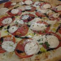Capri's Special White Pizza · Fresh mozzarella, sliced tomatoes, garlic and olive oil.