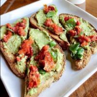 Avocado Toast · Salted avocado seasoned with fresh lime on 9-grain topped with sun-dried tomatoes and cilant...